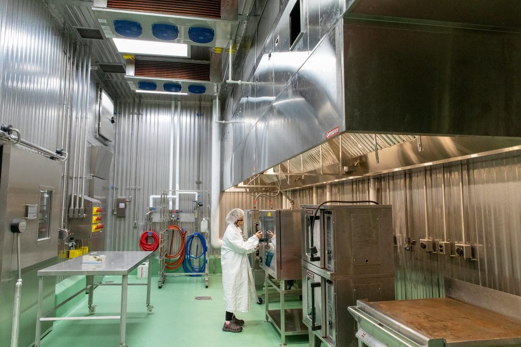 Cindy Austin checks readings on a cabinet smoker in the BSL2 kitchen at MSABD.