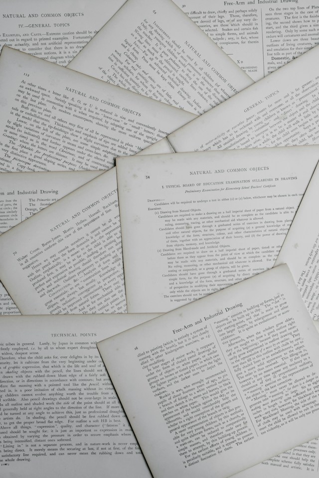 Overlapping hard copies of scientific papers with illegible text.